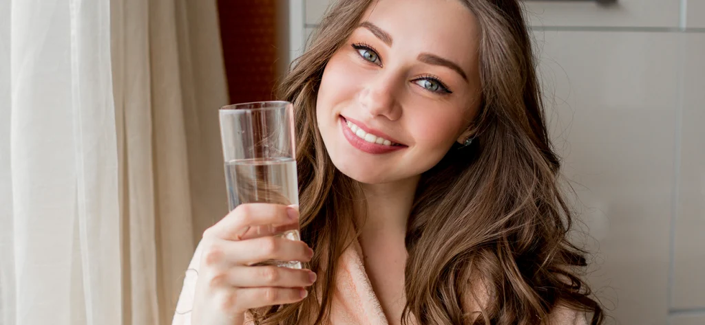woman holding a glass of water