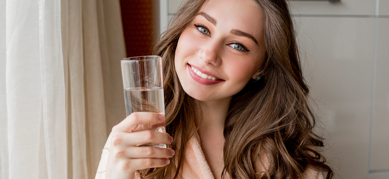 woman holding a glass of water