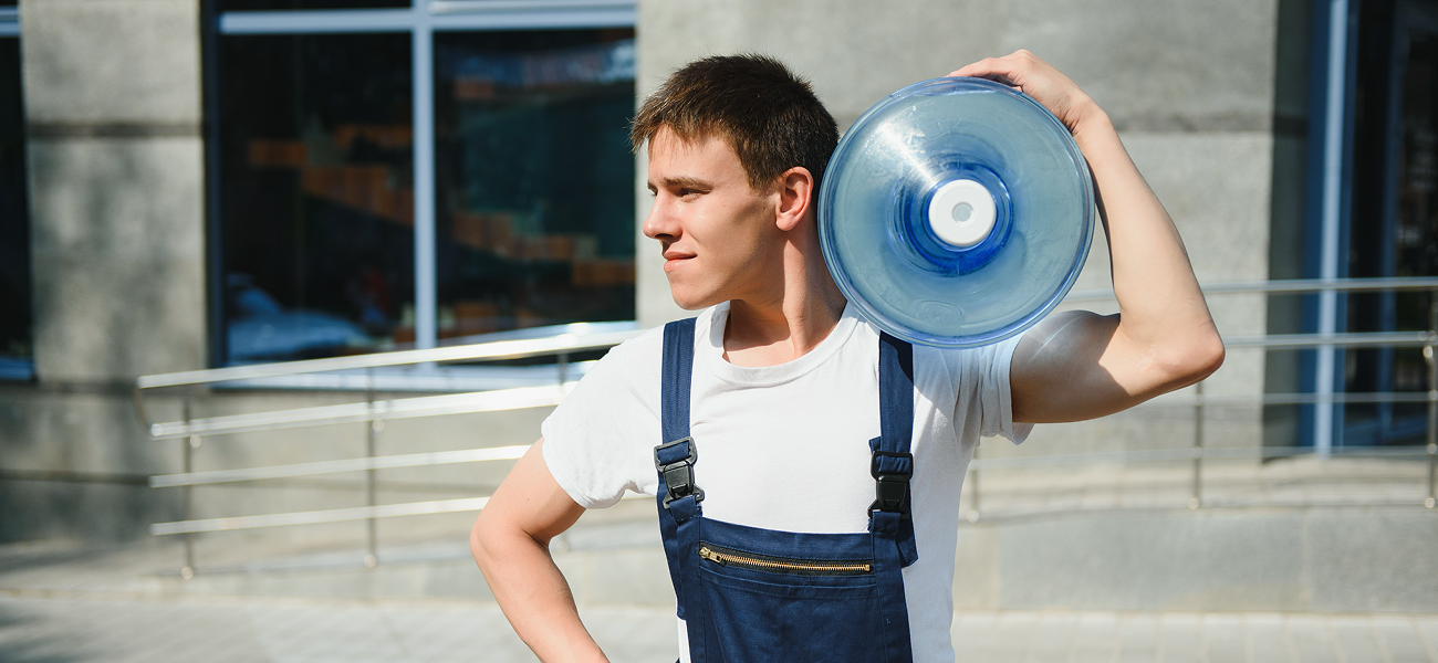 man carrying packaged drinking water